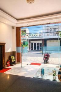 a room with a glass door with a motorcycle inside at Hoàng Lê Hotel in Ho Chi Minh City