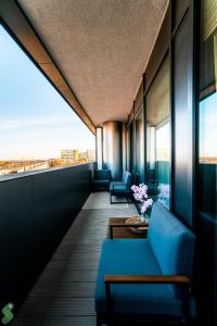 a room with a blue couch and chairs on a building at HANZA Pionier 2 pokoje i balkon SPA & Pool Parking by stayly in Szczecin