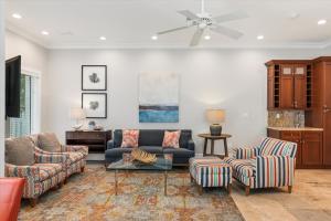 a living room with a couch and chairs at Palm Royale Windsor Townhomes in Key West
