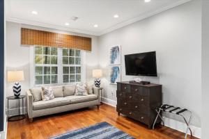 a living room with a couch and a flat screen tv at Palm Royale Windsor Townhomes in Key West