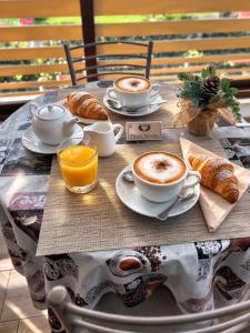 a table with cups of coffee and croissants on it at Villa Ivana in Rome +13 photos