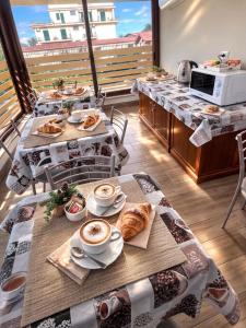 a room with two tables with coffee and croissants at Villa Ivana in Rome