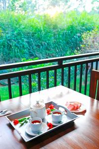 a tray with two cups of tea on a table at Zephyra Ella in Ella