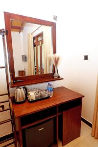 a mirror on top of a wooden vanity in a room at Zephyra Ella in Ella +88 photos