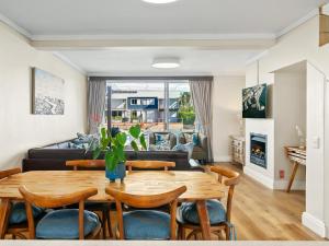 a living room with a table and chairs and a couch at KnysnaQuays 4 in Knysna