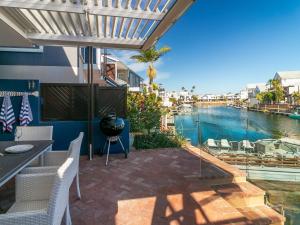 a patio with a view of the water at KnysnaQuays 4 in Knysna