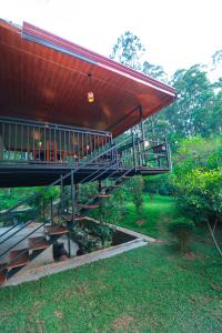 a building with a staircase leading to a porch at Zephyra Ella in Ella