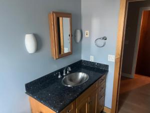 a bathroom with a sink and a mirror at Private room with Fridge - Mini Mansion in Burbank