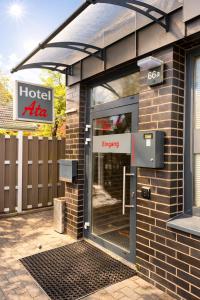 a front door of a hotel entrance with an emergency sign at Ata Hotel - Self Check-in in Hamburg