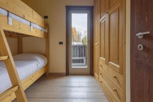 a bedroom with two bunk beds and a door at Oga View Apartment in Oga