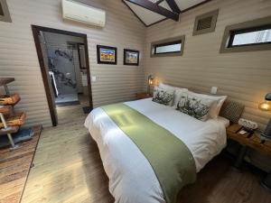 ein Schlafzimmer mit einem großen Bett in einem Zimmer in der Unterkunft Timmerstuga in Malelane