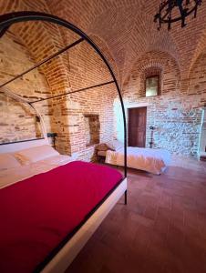 a bedroom with a bed in a brick room at La torre del cappellaio in Fabriano
