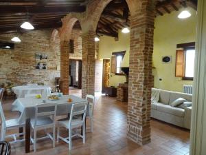 a living room with a table and chairs and a couch at La torre del cappellaio in Fabriano