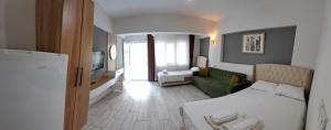 a bedroom with a bed and a living room at Sun Rose Pansiyon in Pamukkale +28 photos