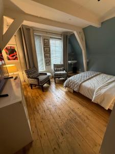 a bedroom with a bed and two chairs at B&B 1971 Hazenstraat - Shared Bathroom in Amsterdam