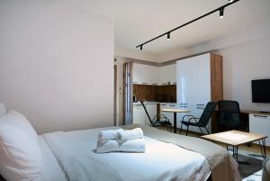 a bedroom with a bed and a table and chairs at Lakeview Apartments in Veles