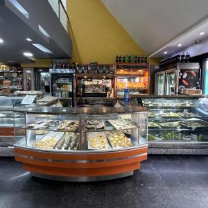 a bakery filled with lots of different types of donuts at Hotel Grand Galaxie in Caracas