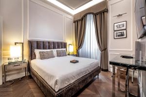 a bedroom with a bed with a desk and a piano at Il Rivalta - Place of Charme in Florence