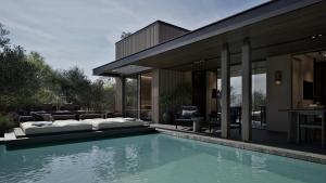 a house with a swimming pool next to a house at Neme Slow Living Retreat in Rethymno +120 photos