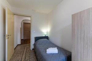 a bedroom with a blue bed in a room at La Cort di Vigje 2 in Ovaro