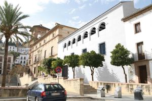 a car parked in front of a white building at Apartamento Cuesta San Judas in Antequera