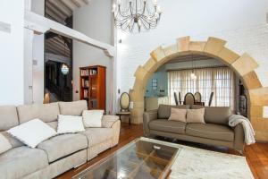 a living room with two couches and a glass table at Luxury Villa Esmeralda in Suances