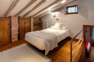 a bedroom with a large bed in a attic at Luxury Villa Esmeralda in Suances +24 photos