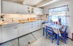 a kitchen with a table and a sink at 4 Bedroom Awesome Home In Ulefoss in Ulefoss