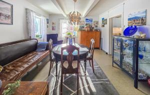 a living room with a table and a couch at 4 Bedroom Awesome Home In Ulefoss in Ulefoss