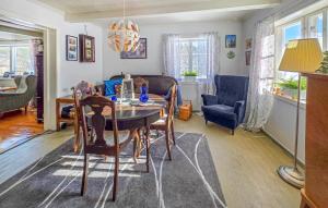 a living room with a table and a couch at 4 Bedroom Awesome Home In Ulefoss in Ulefoss