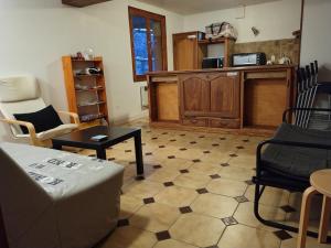 a living room with a couch and chairs and a table at 6 Bis La Capelette in Ax-les-Thermes +6 photos