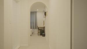 a hallway with a mirror in a white room at Jeju Stay Hotel in Jeju +55 photos