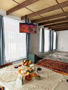 a room with a table with fruit on it at Guesthouse Chon - Kemin in Shabdan +31 photos
