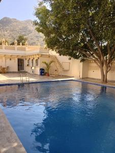 a large swimming pool in front of a house at aurum villa's kodiyat in Nāi