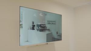 a mirror on a wall in a room at Jeju Stay Hotel in Jeju