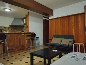a living room with a couch and a kitchen at 6 Bis La Capelette in Ax-les-Thermes