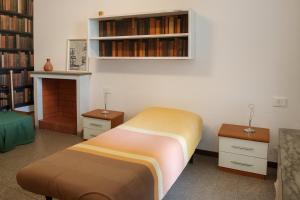 a bedroom with a bed and a book shelf at La vista sul Castello in Cerreto +24 photos