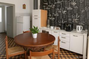 a kitchen with a table and a chalkboard wall at La vista sul Castello in Cerreto