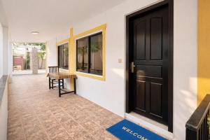 a hallway with a black door and a table at Expat Resort in Siem Reap +5 photos