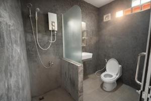 a bathroom with a shower with a toilet and a sink at Expat Resort in Siem Reap
