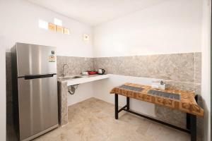 a kitchen with a refrigerator and a table in it at Expat Resort in Siem Reap
