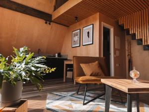a living room with a couch and a table at Mulberynas in Stakliškės