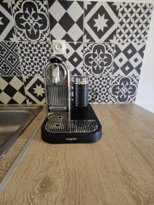 a blender sitting on a counter next to a sink at Studio Serenity - Clim - WIFI - Parking - Piscine - Front de mer - Proche commerces et centre ville in Fréjus