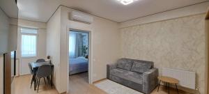 a living room with a chair and a table and a bed at SkyHouse&PrivateGarage in Chişinău