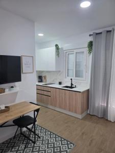 a kitchen with a sink and a table and a counter at Estudio Luminoso AM in Bollullos par del Condado