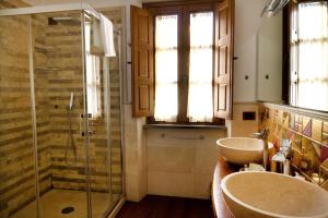 a bathroom with two sinks and a glass shower at La Locanda di Giulia in Arezzo +57 photos