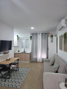 a living room with a couch and a table at Estudio Luminoso AM in Bollullos par del Condado