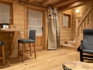 a room with a desk and chairs in a log cabin at Vertigo in Puy-Saint-Pierre +11 photos
