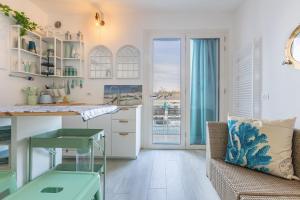 a kitchen with a view of the ocean at GuestHost - Parco del Sole Residence Flat with Terrace in lido degli scacchi