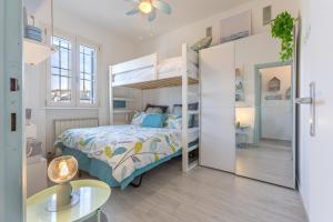 a bedroom with a bunk bed and a table at GuestHost - Parco del Sole Residence Flat with Terrace in lido degli scacchi +27 photos
